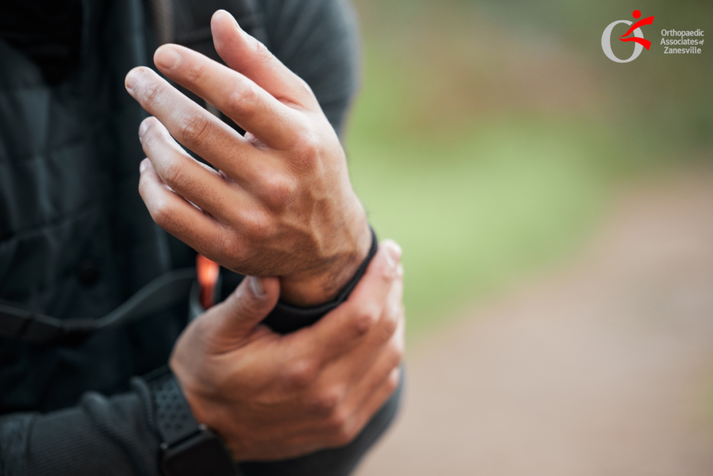 A man holding his wrist in pain after an injury that broke it in Ohio.